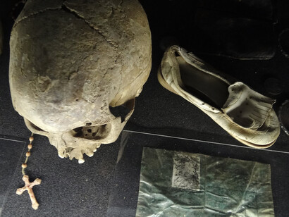 Skulls and personal belongings of genocide victims displayed at the Genocide Memorial Center in Kigali, Rwanda