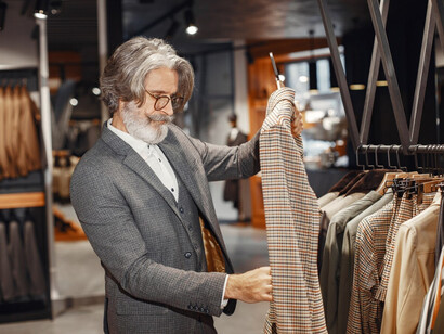 A man examining fabric discerning eye of true quality and style of Loro Piana