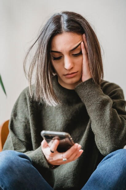 Woman exhausted while looking at a phone