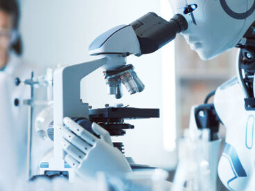 Woman collaborating with an android robot in a modern science lab