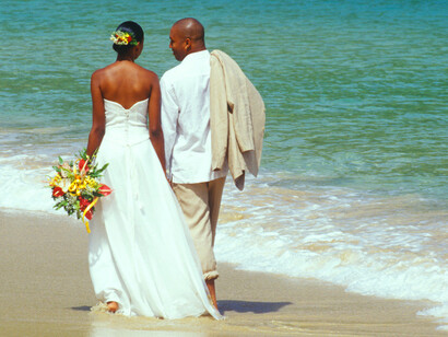Married couple walking on beach