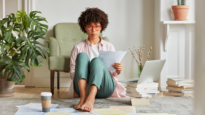 Embracing the flexibility of hybrid work, this woman enjoys the freedom to balance professional tasks with personal moments from the comfort of her home