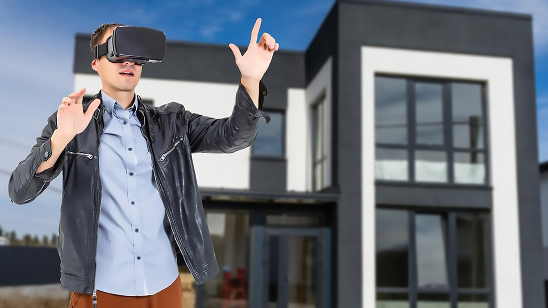 Man wearing VR glasses explores a new house design, showcasing VR technology in construction