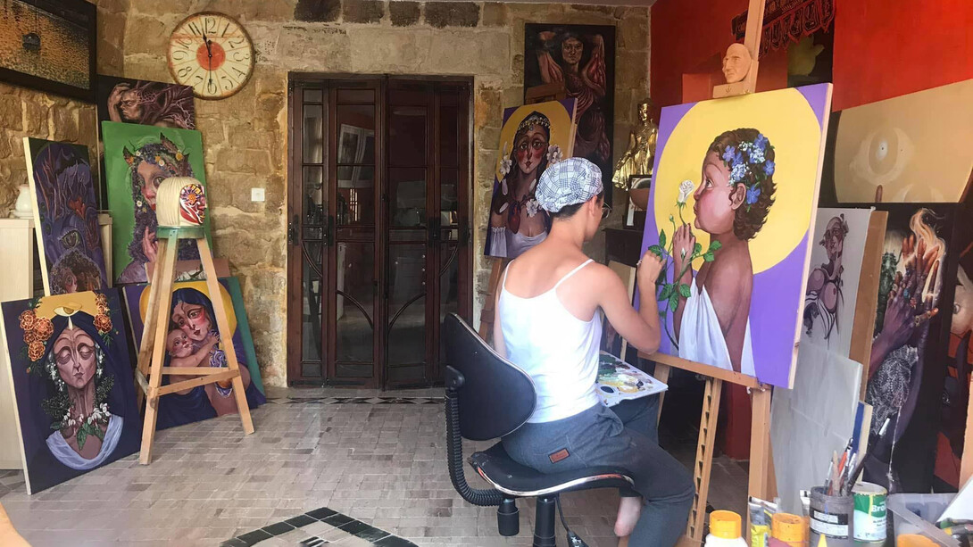 Nik Keter works on a painting in the series titled 'In the Name of the Mother and the Daughter'