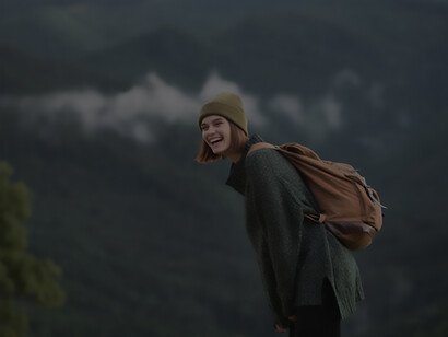 Embarking on a solo adventure, a woman immerses herself in the enchanting rural scenery, finding solace and joy in the simplicity of her solo travel experience