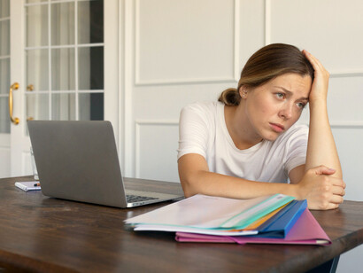 Trabajadora procrastinando. La procrastinación va más allá de simplemente retrasar una tarea; es aplazar sin intención de concretarla en el futuro cercano