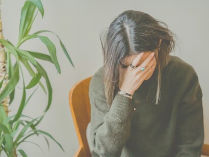 A woman despairing at herself for making a mistake