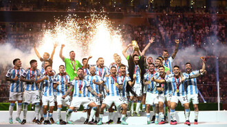 Lionel Messi lifts the 2022 FIFA World Cup trophy with his Argentina teammates