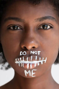 A close-up captures the impassioned expression of a Black woman as she delivers a powerful message of revolution, embodying the spirit of change and empowerment