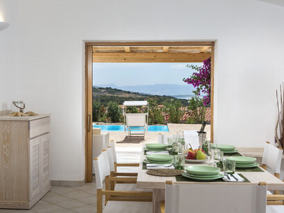 The historic red tower stands proudly over the coastline, a symbol of Sardinia’s charm, Italy