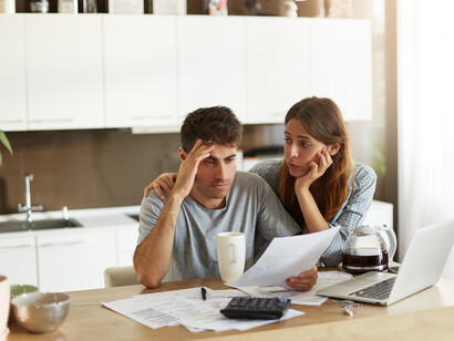 A young couple checking their family budget