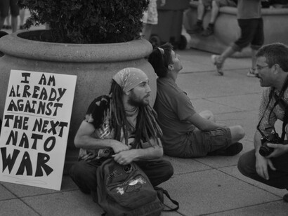 Crowds gather to protest NATO actions, marching through city streets