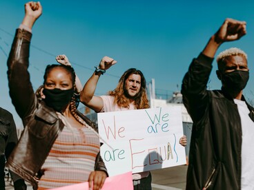 Youth march through the streets with placards in hand, calling for change and justice