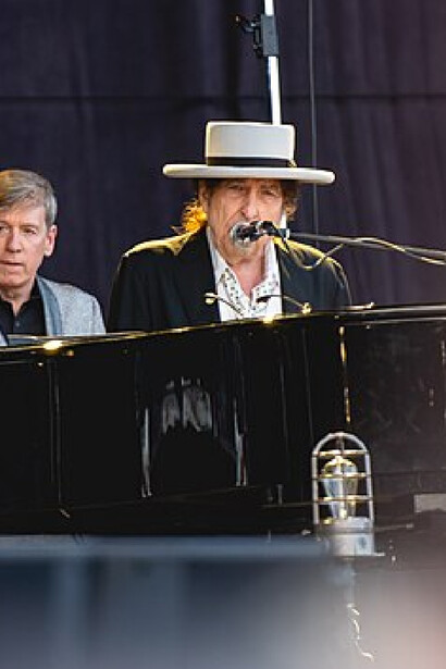 Bob Dylan plays the piano during his performance in Nowlan Park, Kilkenny, Ireland showcasing his skills and rhythm 