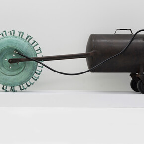Tao Kulczycki, Wheel-barrow of life (Bhavacakra, cyclic existence), 2014, bronze (wheel-barrow tire, ear aids) green patina, steel (modified air tank), air hose and valve, 20.5 x 56 x 12 in.