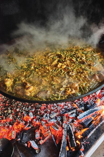 Paella is the traditional rice dish prepared with short-grain rice, olive oil, saffron, and a flavorful broth. Photography by Joan Pujol-Creus