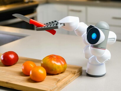 An AI robot chef has a knife to slice and dice tomatoes