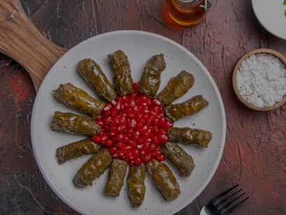 Yaprak sarma, a traditional Turkish dish, consists of grape leaves stuffed with a savory mixture of rice and spices, representing an essential part of Turkish cuisine