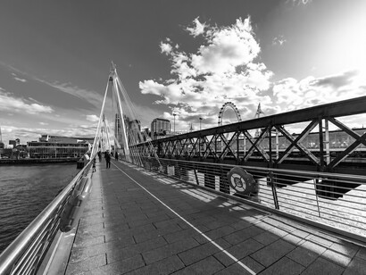 Pedestrians crossing the Golden Jubilee Bridge in London, UK