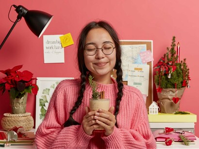 A smiling woman surrounded by personal goals and routines, symbolising the importance of grounding self-worth internally rather than externally