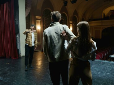 People preparing for a play on the theatre stage