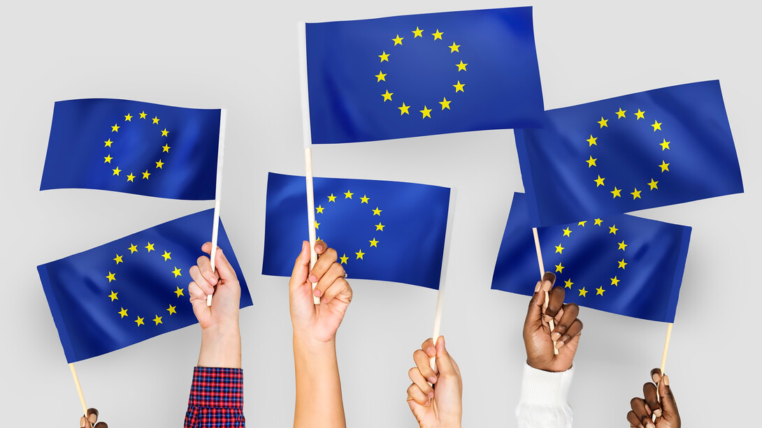 Hands waving flags of the European Union