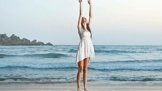 Woman celebrating her accomplishments at the beach