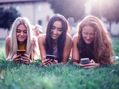 Chicas felices con sus celulares. Hoy la gran mayoría de la gente es incapaz de sentarse a leer un libro. La gente lee memes