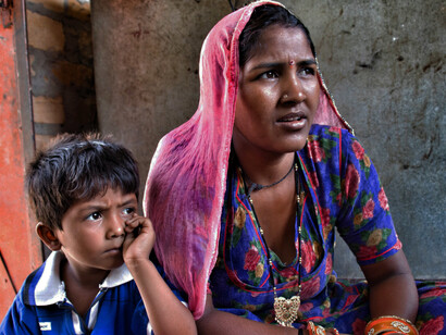 Jaisalmer, Rajasthan, India. An Indian woman with her son on a street