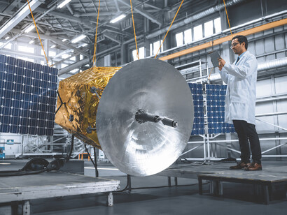 Aerospace specialists collaborate on the construction of a satellite, combining technical expertise and innovative technology to prepare for future missions