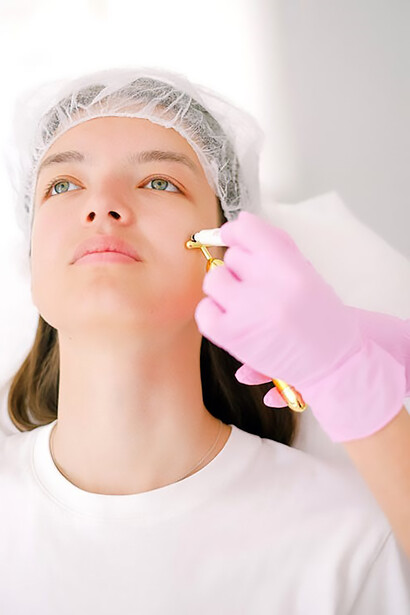 Embrace a vibrant change as a young woman undergoes skillful filler application by a doctor donning pink gloves, unveiling a revitalized facial appearance