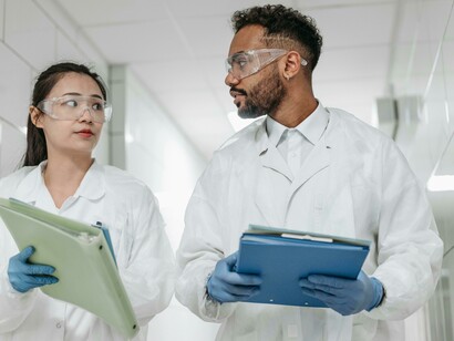 A man and woman walk through a hallway in a modern innovation lab, where scientists collaborate as part of a research and development team