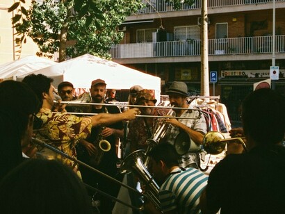 A group of musicians brings life to a quiet Spanish street, showcasing the strength and unity of the local community