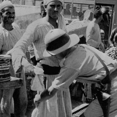 Un agente británico cachea a un hombre en Jerusalén en la época del Mandato británico de Palestina