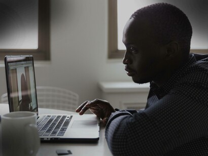 An intern working on his laptop after receiving a tutorial