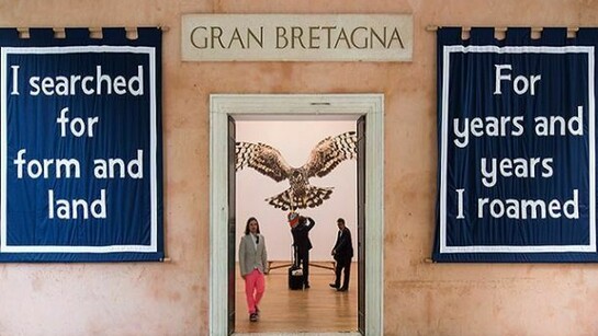 Jeremy Deller walks towards the entrance of the British Pavilion, where his installation English Magic is on show