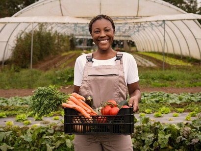 A woman cultivating plants in a city garden, exemplifying sustainable agriculture and enhancing urban green spaces