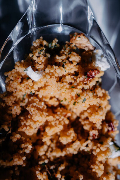 Close-up of perfectly steamed couscous, a staple grain that shares the spotlight with Rfissa as a cherished Moroccan comfort food