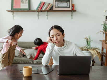 A mother dealing with the noise her children are making in the background