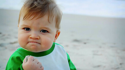A meme of a baby making a fist, often used to humorously convey determination or a playful attitude
