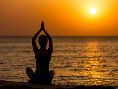 A sunrise meditation by the sea, reflecting the yogic connection between breath, awareness, and vitality