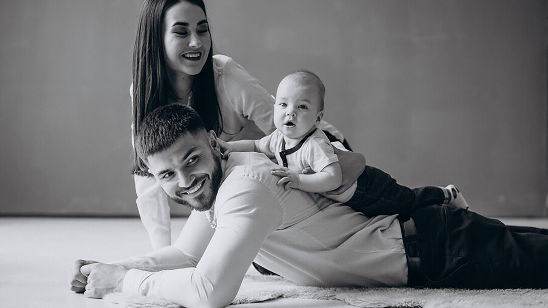A happy family embracing the joys of parenthood with their first child