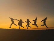 Five people jumping together