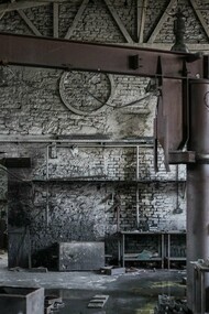 A forgotten factory space with high ceilings and exposed framework, representing the potential for converting industry into habitation