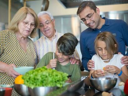 Family members working together to cook in the kitchen