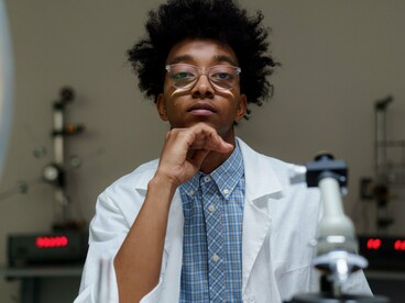 A Black scientist advancing research , reflecting the courage to challenge boundaries and create lasting change