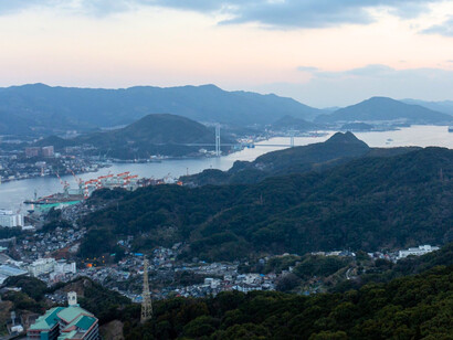 A panorama from Mount Inasa overlooking Nagasaki Harbour, representing the city's mountains, sea, and urban life