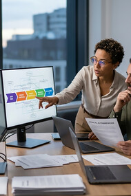 A diverse team of experts collaborates to design a human-centered AI framework, prioritizing transparency, data ethics, and sustainability for a safer digital future