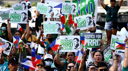 Protesters hold placards and wear symbolic colors as they demand justice and challenge the legitimacy of the ICC’s actions
