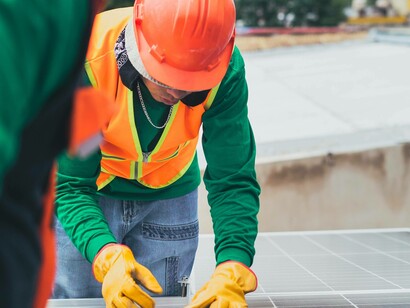 Construction workers installing an energy-efficient solar panel